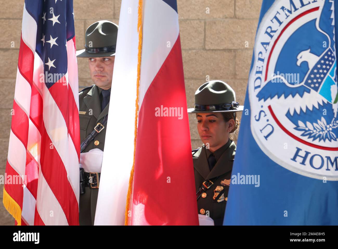 The United States, Texas and Department of Homeland Security flags are shown during Border