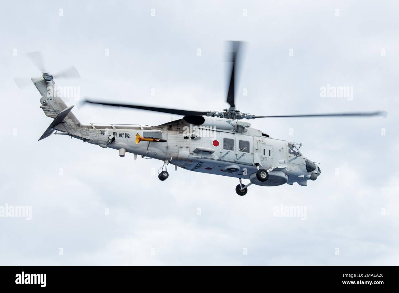 220526-N-BR419-1171 PHILIPPINE SEA (May 26, 2022) A Japan Maritime Self-Defense Force (JMSDF) SH-60K Seahawk, attached to the JMSDF destroyer JS Teruzuki (DD 116), flies over the flight deck of the U.S. Navy’s only forward-deployed aircraft carrier USS Ronald Reagan (CVN 76). The U.S. Navy and JMSDF routinely conduct naval exercises together, strengthening the U.S.-Japan alliance and maintaining a free and open Indo-Pacific region. Ronald Reagan, the flagship of Carrier Strike Group 5, provides a combat-ready force that protects and defends the United States, and supports alliances, partnershi Stock Photo