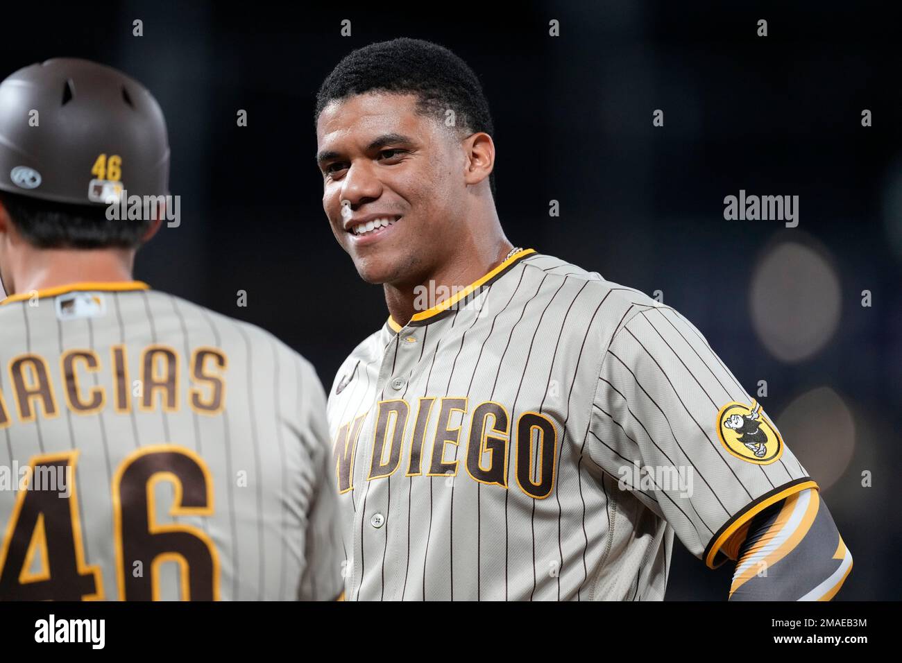 San Diego Padres left fielder Juan Soto celebrates his two-run single with  first base coach David Macias (46) against the Detroit Tigers in the fifth  inning of a baseball game, Saturday, July