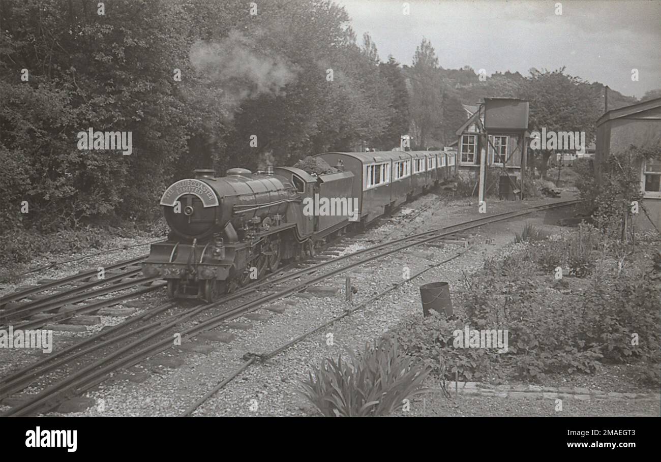 Romney Hythe & Dymchurch Railway 4-6-2 Pacific locomotive No.3 'Southern Maid' hauls The Bluecoaster Ltd. out of Hythe station in about 1937 Stock Photo