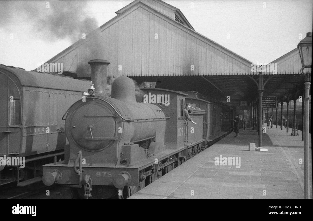 LNER Class J21 0-6-0 No.875 at Penrith Station in the 1930s with a train for Barnard Castle Stock Photo