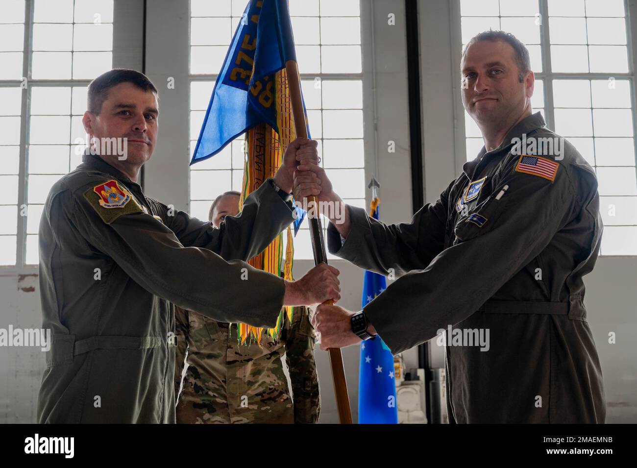 U.S. Air Force Col. Bradely Stevens, 375th Operations Group commander, hands the 458th Airlift Squadron guidon to Lt. Col. Geoffrey Goldsmith, 458th AS incoming commander, during the 458th AS Change of Command at Hangar 3 on Scott Air Force Base, Illinois, May 26, 2022. The ceremony represents a time-honored military tradition providing an opportunity for Airmen to witness the transfer of power to their newly appointed commanding officer. (U.S. Air Force Airman 1st Class Mark Sulaica) Stock Photo