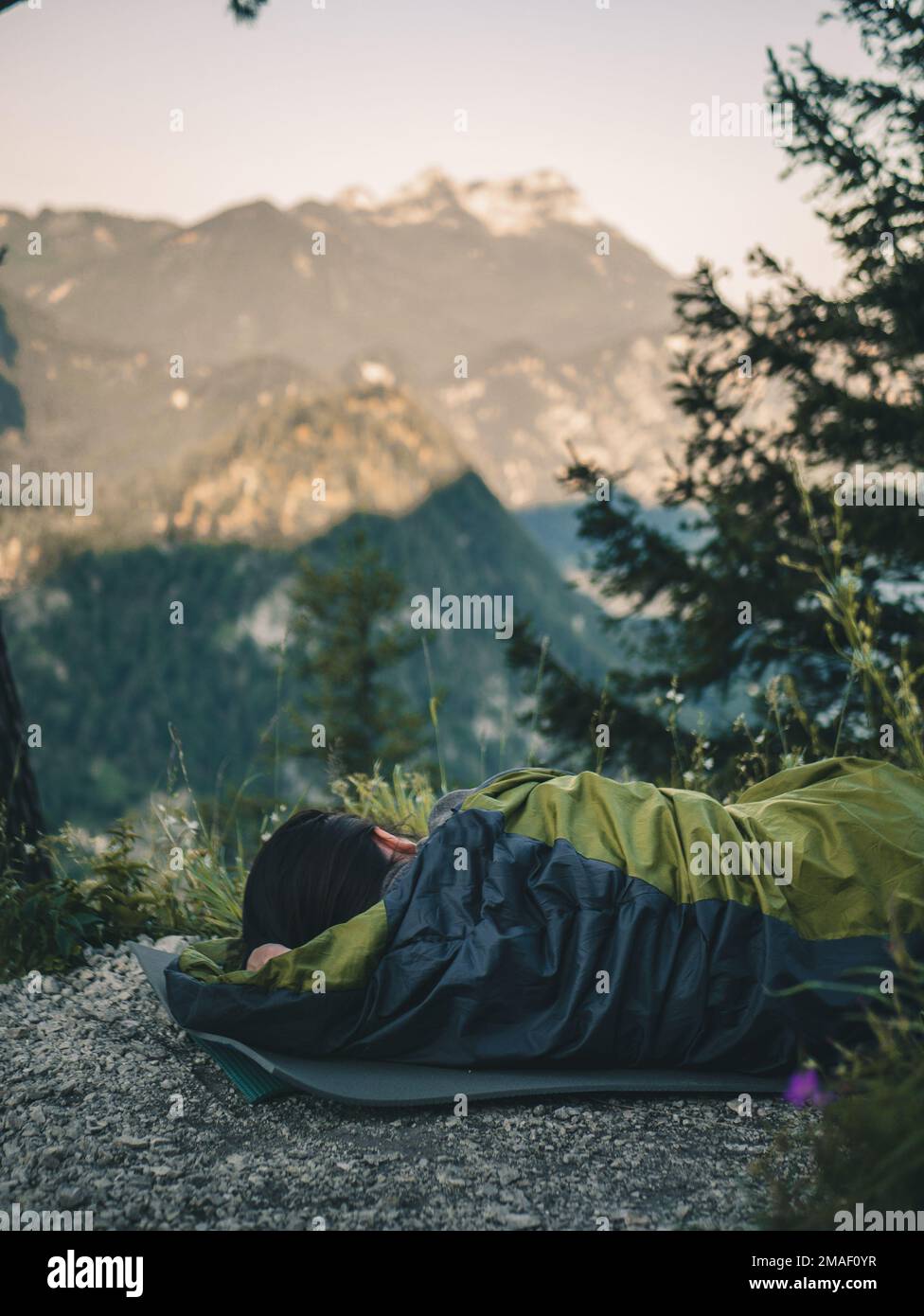 Men and woman with camping accessories standing in field Stock