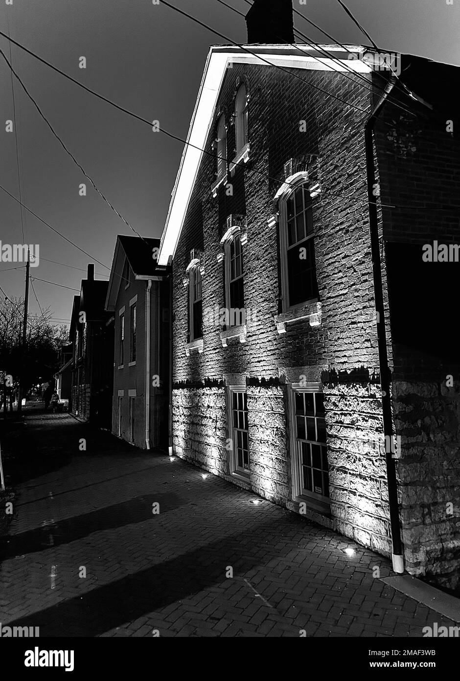 A grayscale vertical shot of buildings row in small street Stock Photo ...