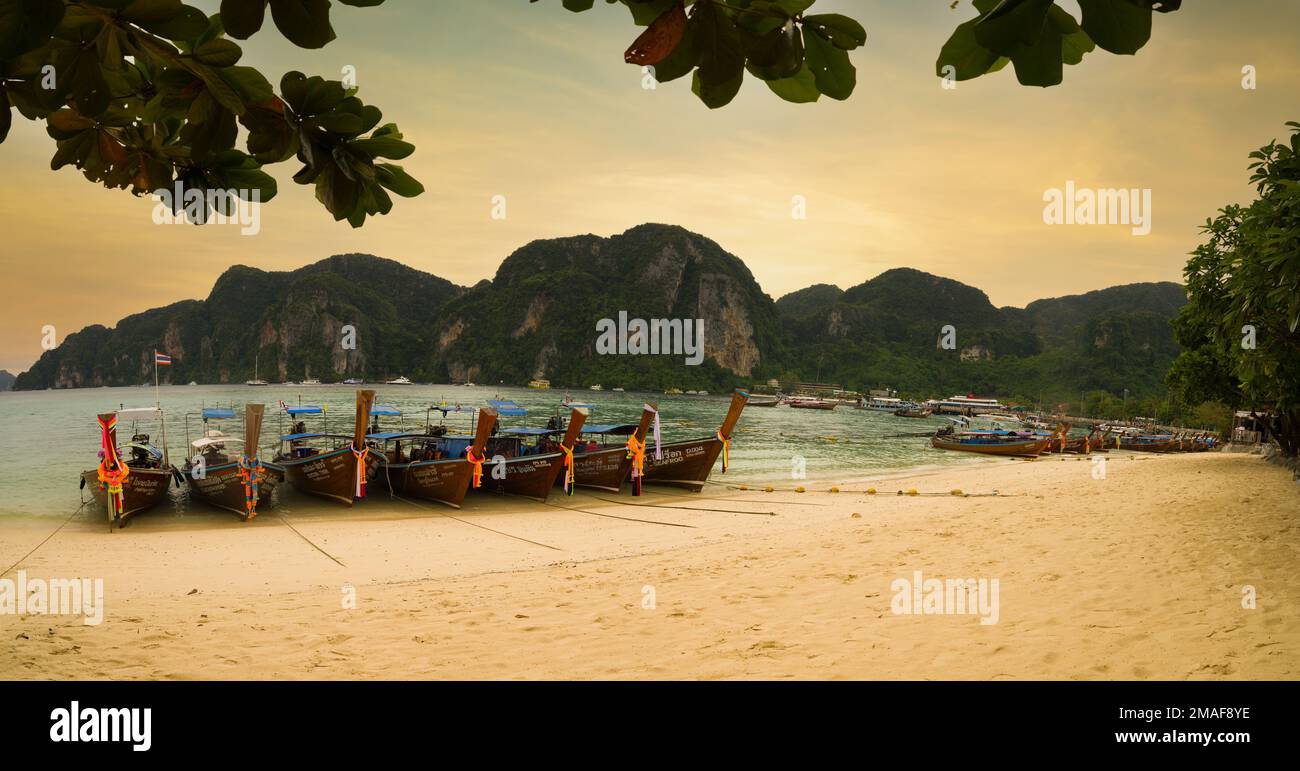 Phi Phi Island, Krabi, Thailand. December 3, 2022. The famous Ton Sai beach at sunset time. Traditional tour boats on the beach and beautiful bay view Stock Photo