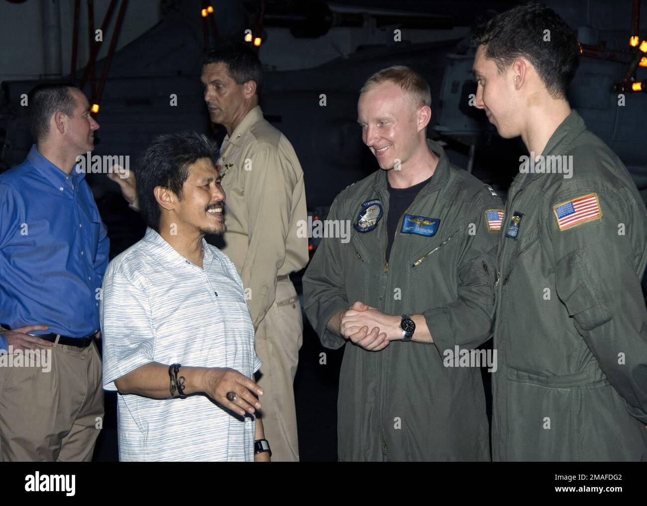 060509-N-9898L-021. [Complete] Scene Caption: His Royal Highness, Prince Mohamed, Foreign Minister of Brunei, and Charge D'Affaires of Brunei Jeff Hawkins (far left), meet the US Navy (USN) Nimitz-class aircraft carrier USS ABRAHAM LINCOLN (CVN 72), Executive Officer (XO), Captain (CAPT) D. A. Lausman and members of Helicopter Anti-Submarine Squadron Light 47 (HSL-47) while on a tour of the ship.2006) - His Royal HighnessPrince MohamedForeign Minister of Bruneiand Jeff HawkinsCharge D'Affaires of Brunei meet USS Abraham Lincoln s (CVN 72) Executive OfficerCAPT. D. A. Lausmanand members of Heli Stock Photo