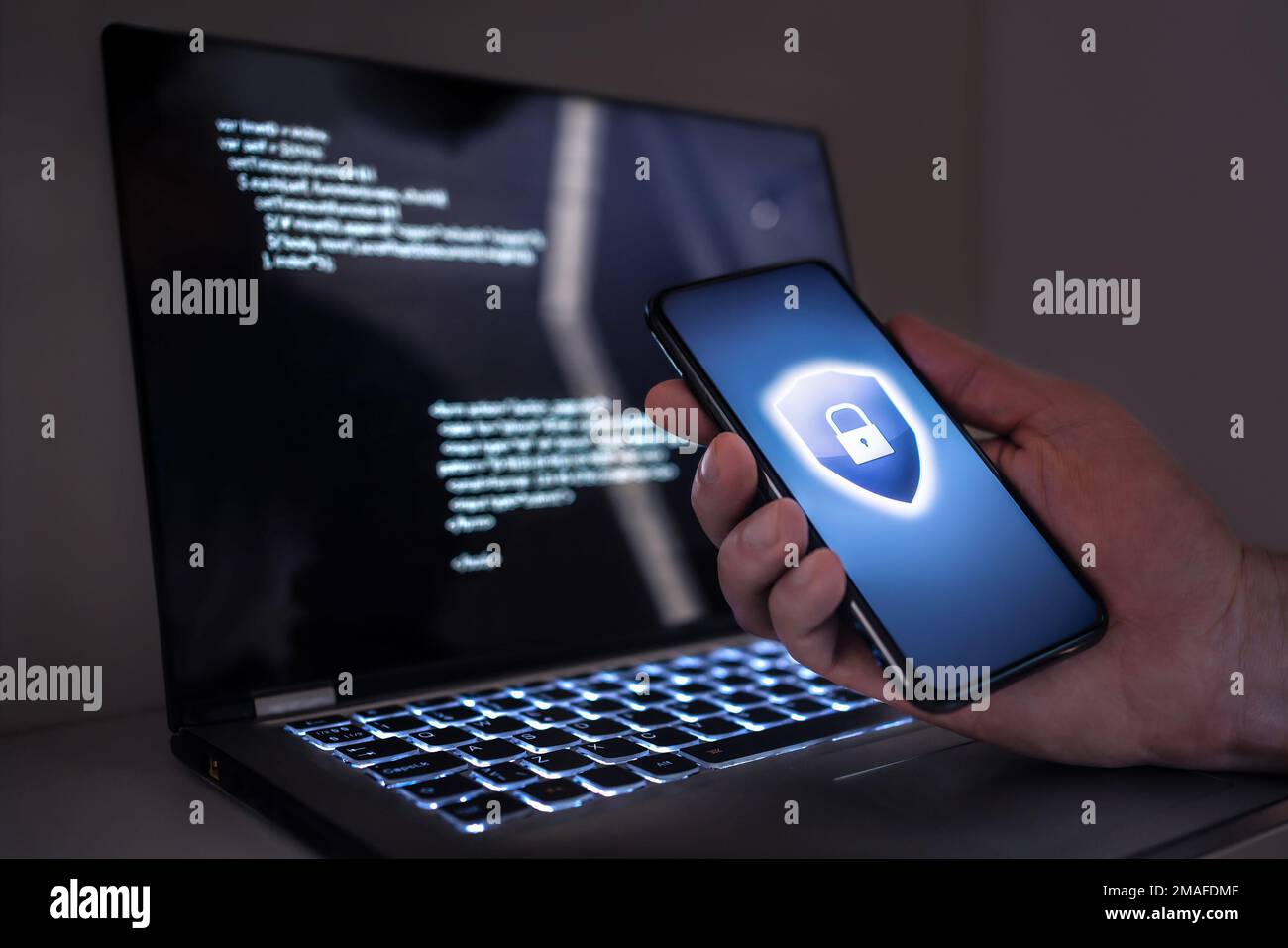 Cyber security in phone and laptop to protect from fraud, cybersecurity attack or identity theft. Electronic mobile scam, online computer data crime. Stock Photo