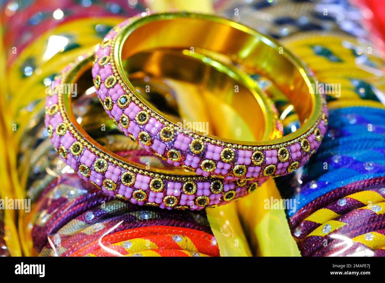Indian Gold bangles displayed in local shop in a market of Pune, India, These bangles are made