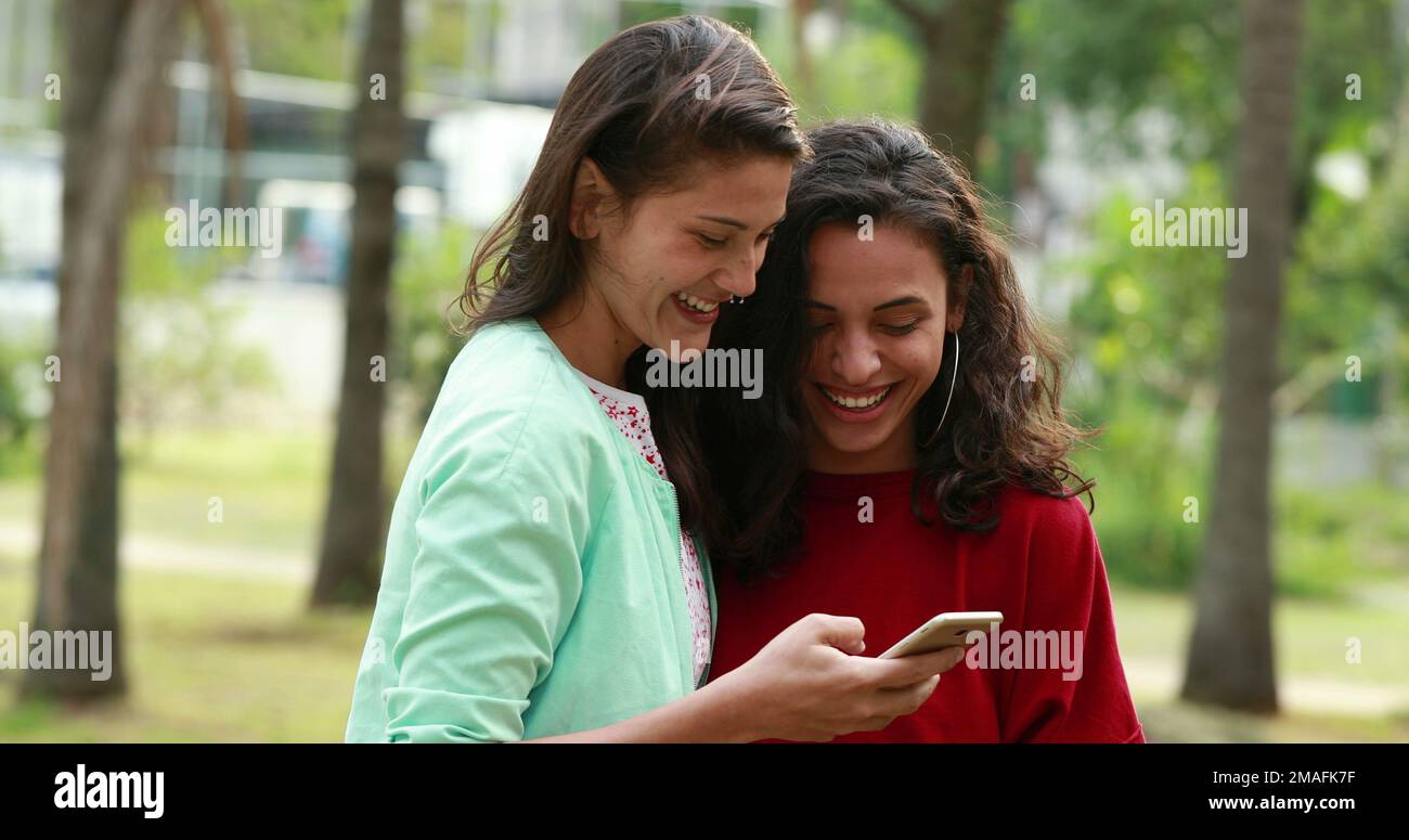 candid lesbian Candid two lesbian women kissing at park looking at cellphone Stock Photo - Alamy