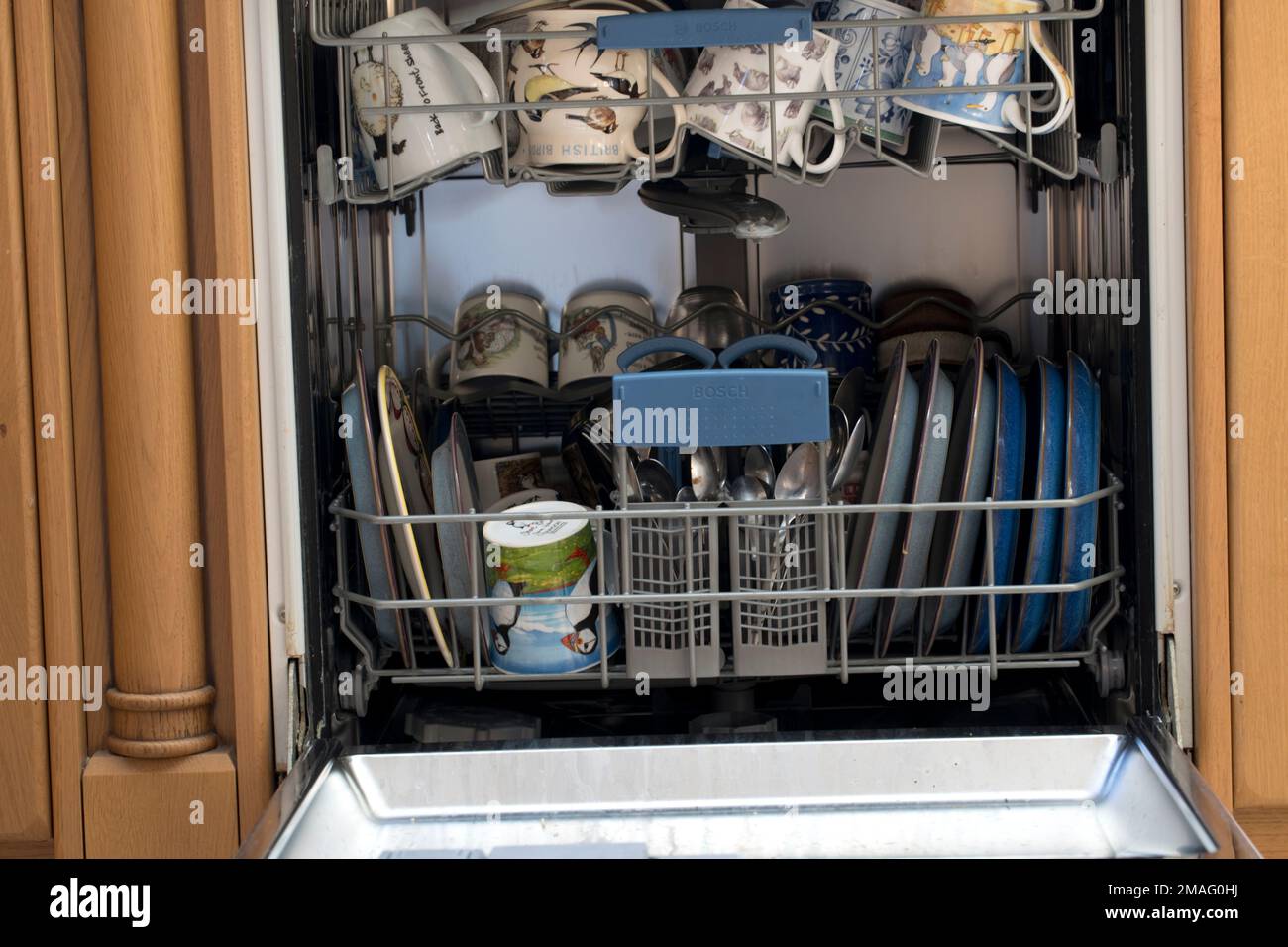 Bosch dishwasher with door open fully loaded UK Stock Photo Alamy