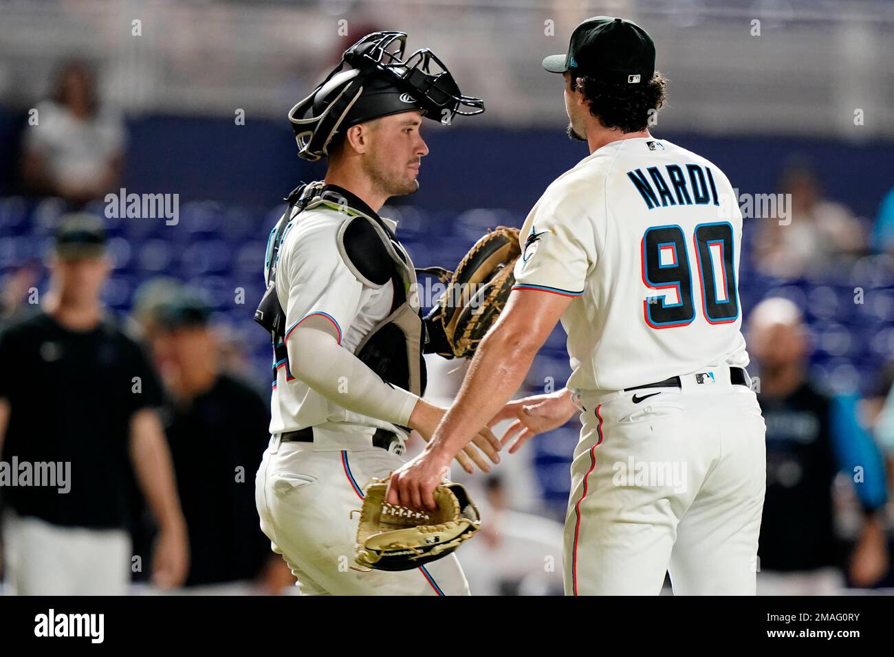 Miami Marlins catcher Nick Fortes, left, shakes hand with relief