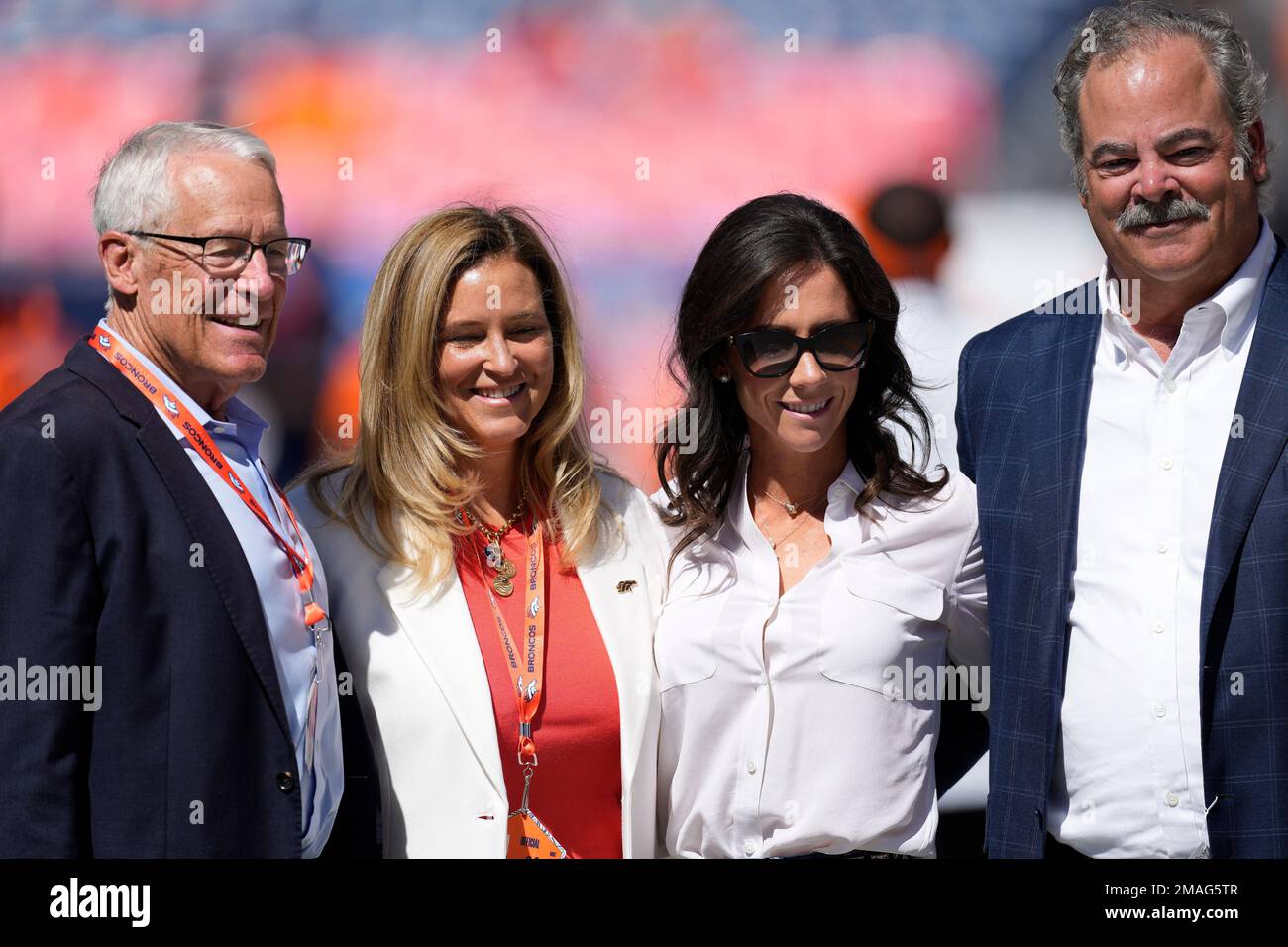 From left, Denver Broncos owners Rob Walton and his daughter, Carrie Walton  Penner, join Hannah McNair and her husband, Houston Texans chairman and  chief executive officer Cal McNair, before an NFL football