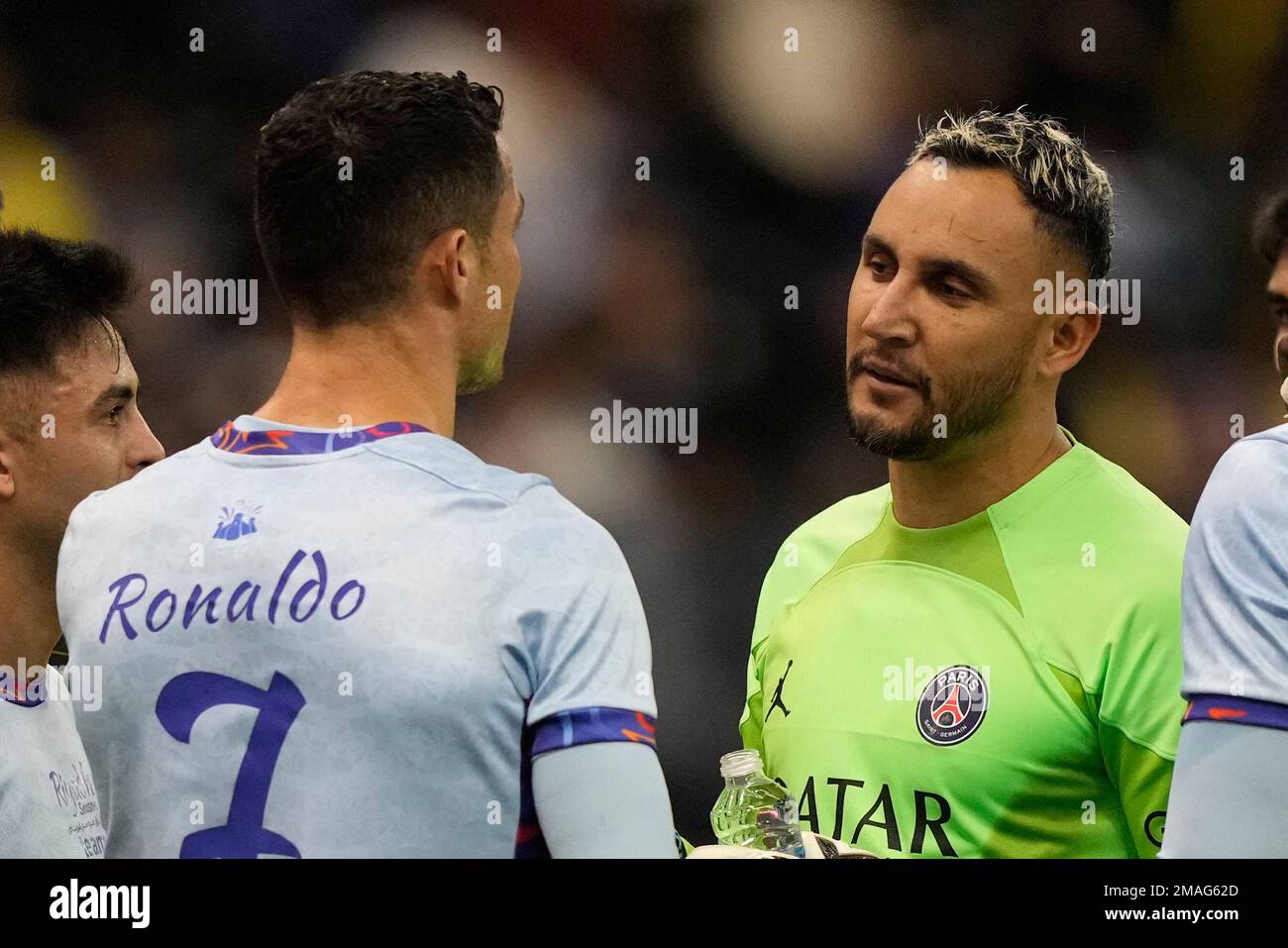 Cristiano Ronaldo talks with PSGs goalkeeper Keylor Navas as he plays for a combined XI of Saudi Arabian teams Al Nassr and Al Hilal against PSG during a friendly soccer match, at