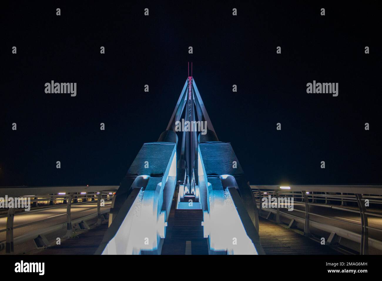 metal structure bridge where you can see braces, pillars, its bike lane