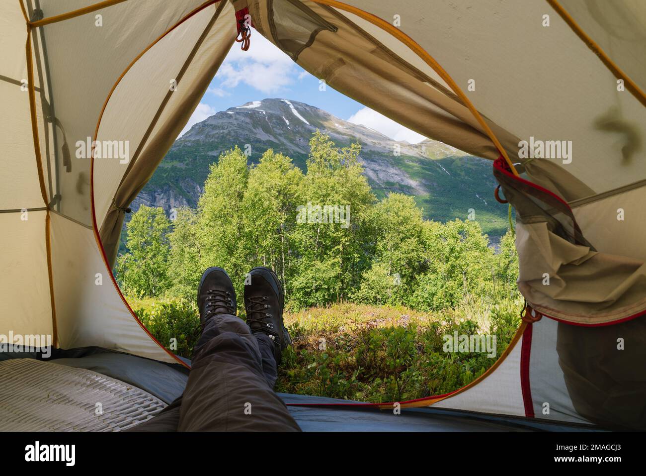 View of the Norwegian mountains from a tourist tent in a camping. Guy
