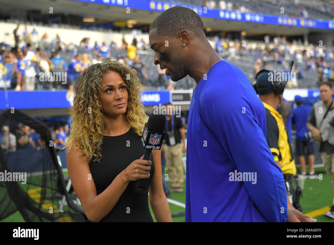 NFL Network reporter Kayla Burton, left, interviews Dallas Cowboys