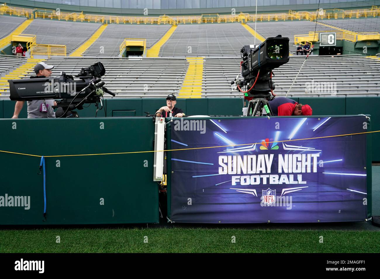 Workers set up Sunday Night Football cameras before an NFL football