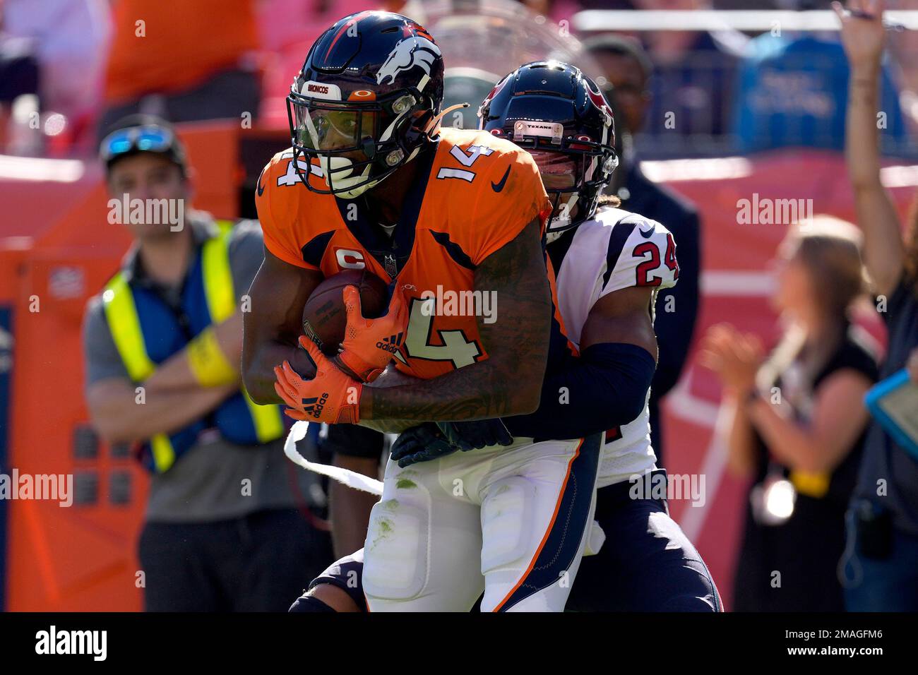 Denver Broncos wide receiver Courtland Sutton (14) is tackled by Houston Texans cornerback Derek