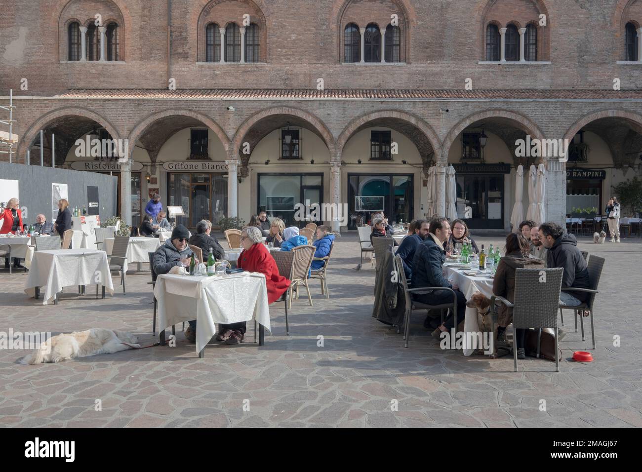 People sitting on square at restaurants outdoors Mantova, Italy Stock Photo