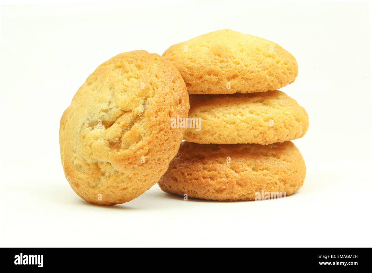 Stack of golden colour biscuits isolated on white background Stock Photo