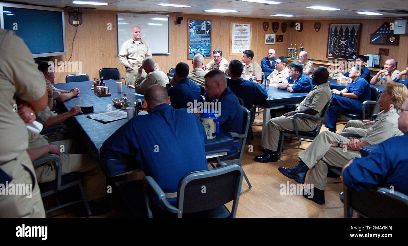 061215-N-3228J-090. [Complete] Scene Caption: U.S. Navy L.Y. Spear Class Submarine Tender USS FRANK CABLE (AS 40) Command MASTER CHIEF Mark Fiorey meets with members of the ship's chief's mess on Dec. 15, 2006, to discuss the status of Sailors who suffered severe steam burns during a Dec. 1 boiler explosion aboard the ship. Command MASTER CHIEF Fiorey recently returned from an eight-day visit with the Sailors and their families at Brooke Army Medical Center in San Antonio, Texas. Of the six Sailors who were sent there for care, one has been released for out patient treatment and one passed awa Stock Photo
