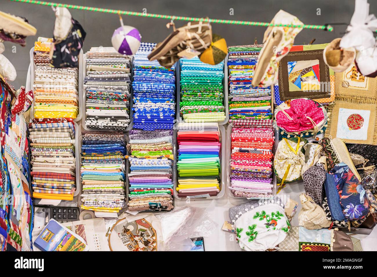 High angle view of trading place with accessories for handmade craft. Many various pieces of fabrics, patchwork hobby. Sale. Top view Stock Photo