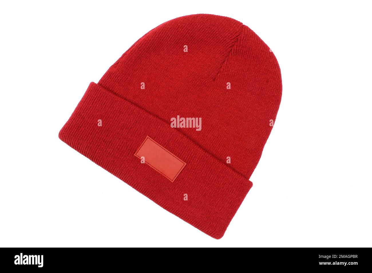 Blank red winter hat for men with blank label template isolated on white background. Classic woolen beanie cap Stock Photo