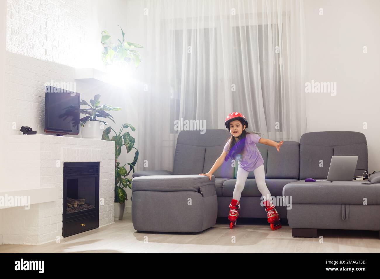 little girl is roller skating at home Stock Photo Alamy