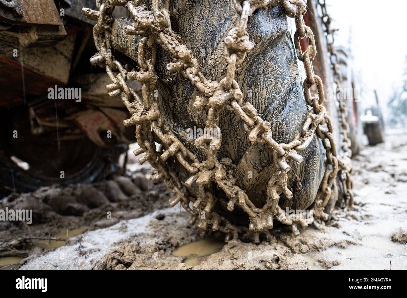 Closeup for extreme big off road 4x4 vehicle wheel with a snow and mud
