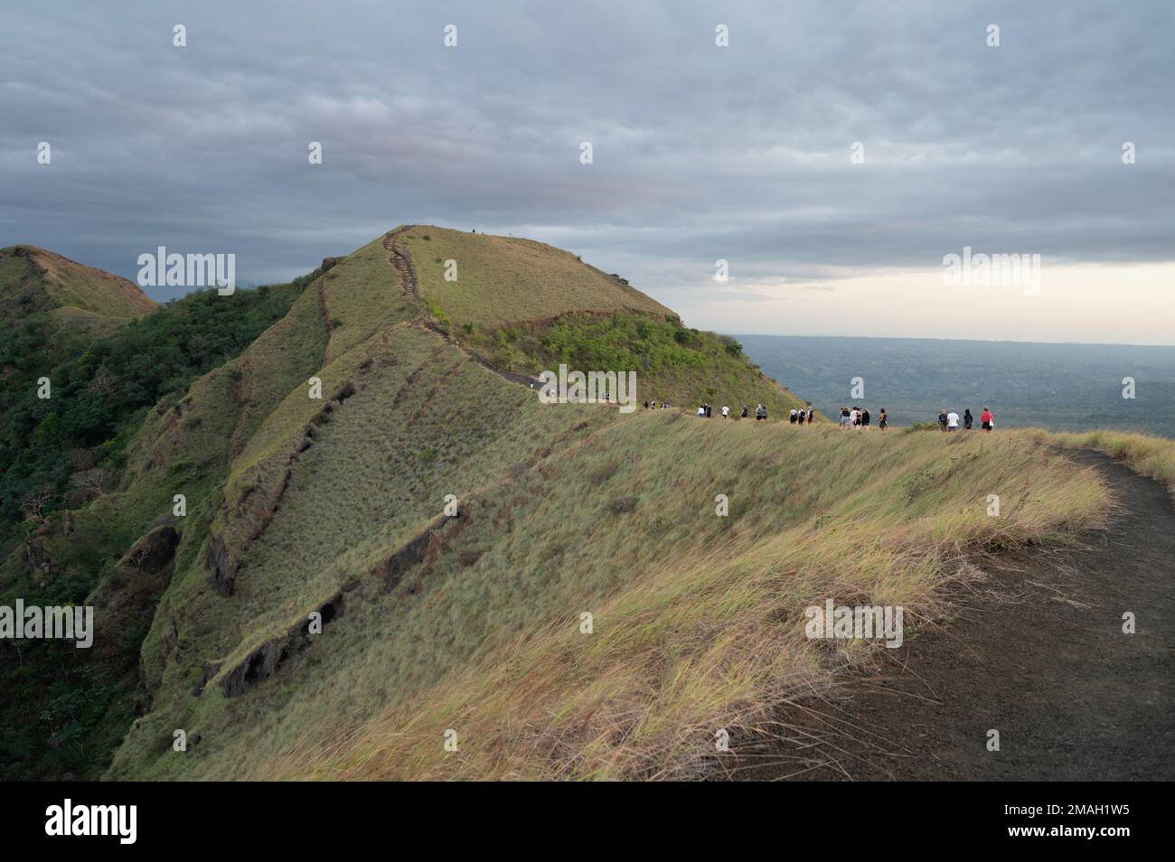 Group of tourist people on hike walking in volcano crater edge Stock Photo