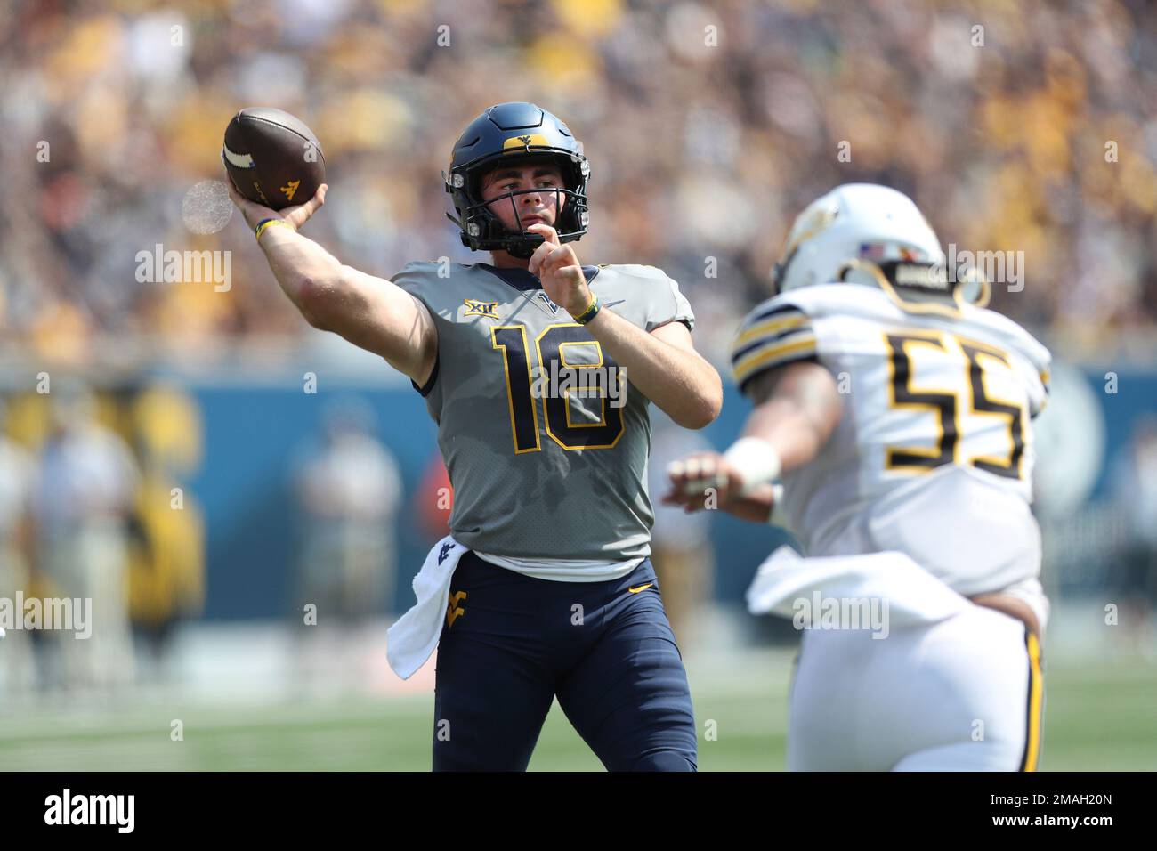 West Virginia QB JT Daniels 18 lobs a first half touchdown pass against Towson during an NCAA
