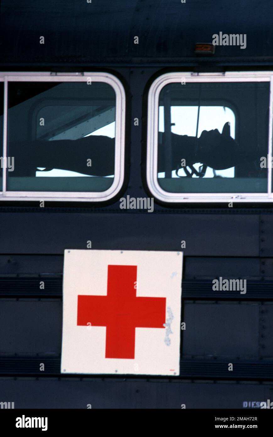 A view through the window of a patient laying on a stretcher onboard a