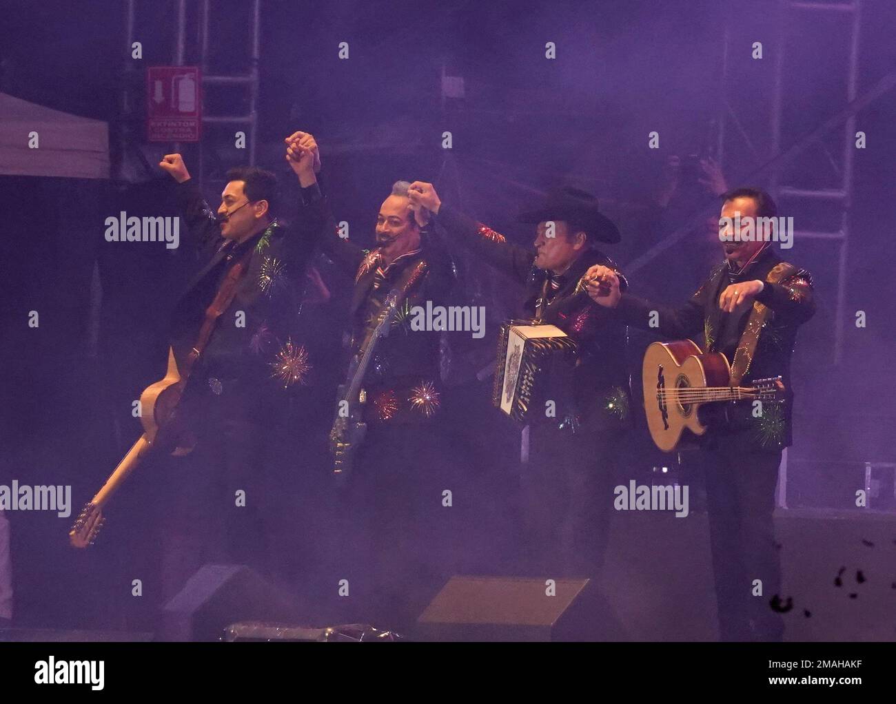 The Norteño band Los Tigres del Norte raise their arms during an ...