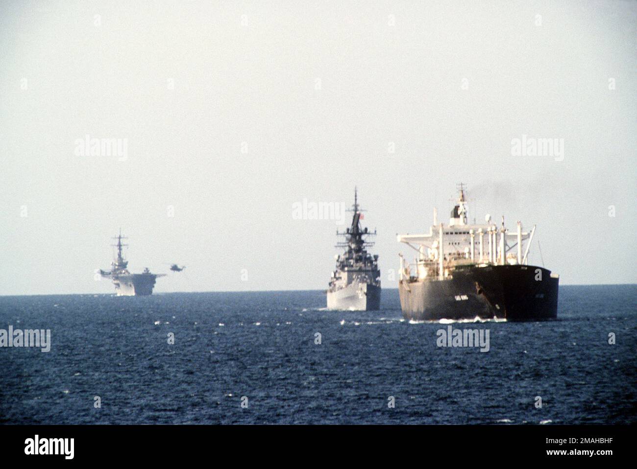 A starboard bow view of ships from tanker convoy No. 12 underway in the