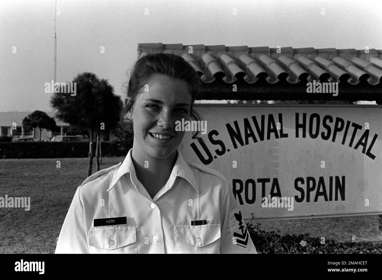 PETTY Officer 2nd Class Kathleen Kerr, a hospital corpsman, poses in front of a sign at the U.S. Naval Hospital, where she is assigned. Base: Rota Country: Spain (ESP) Stock Photo