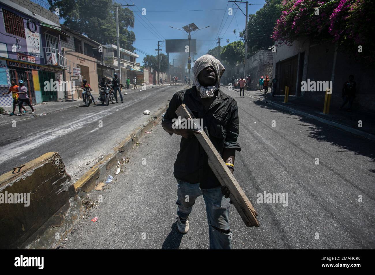 A protester carries a piece of wood simulating a weapon during a ...