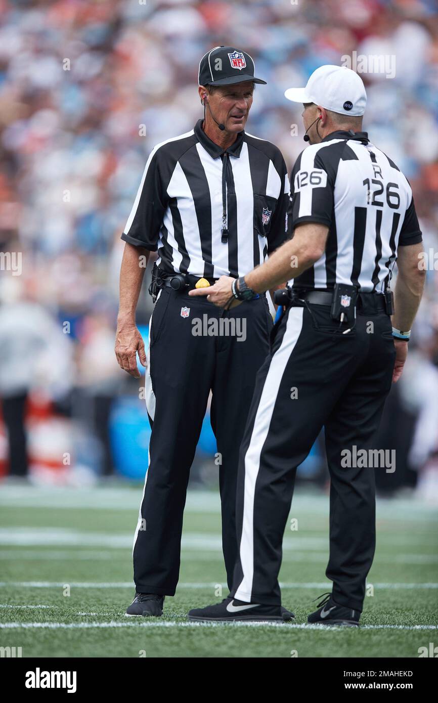 Referee Brad Rogers, left stands with replay official Durwood Manley before  an NFL football game between the Los Angeles Rams and the Las Vegas Raiders,  Thursday, Dec. 8, 2022, in Inglewood, Calif. (