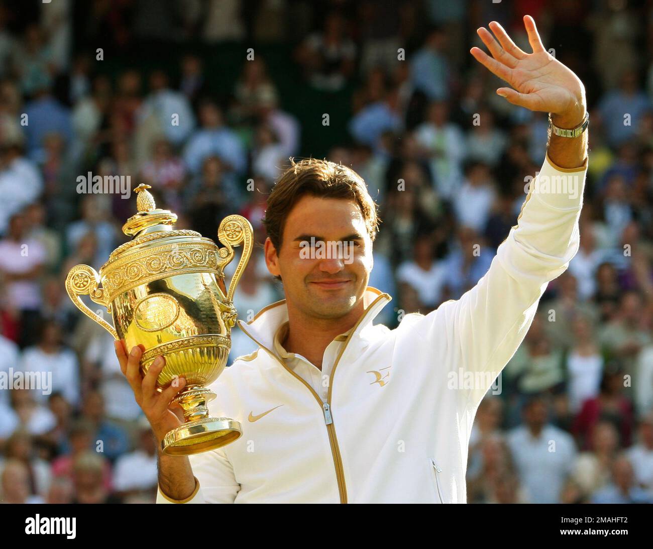 FILE - Roger Federer of Switzerland holds the trophy after defeating ...