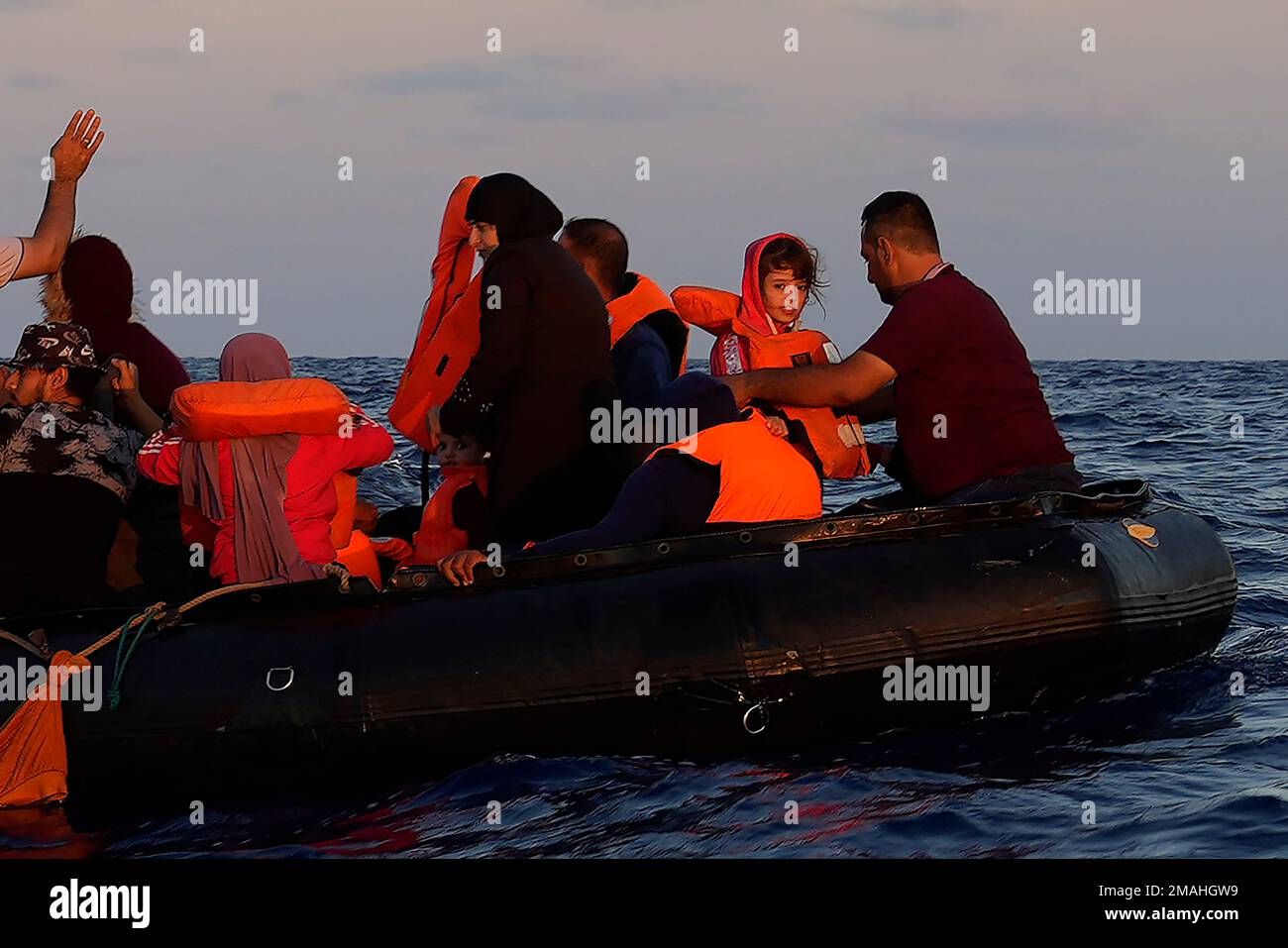 Migrants wait to be rescued by the Spanish NGO Open Arms lifeguards ...
