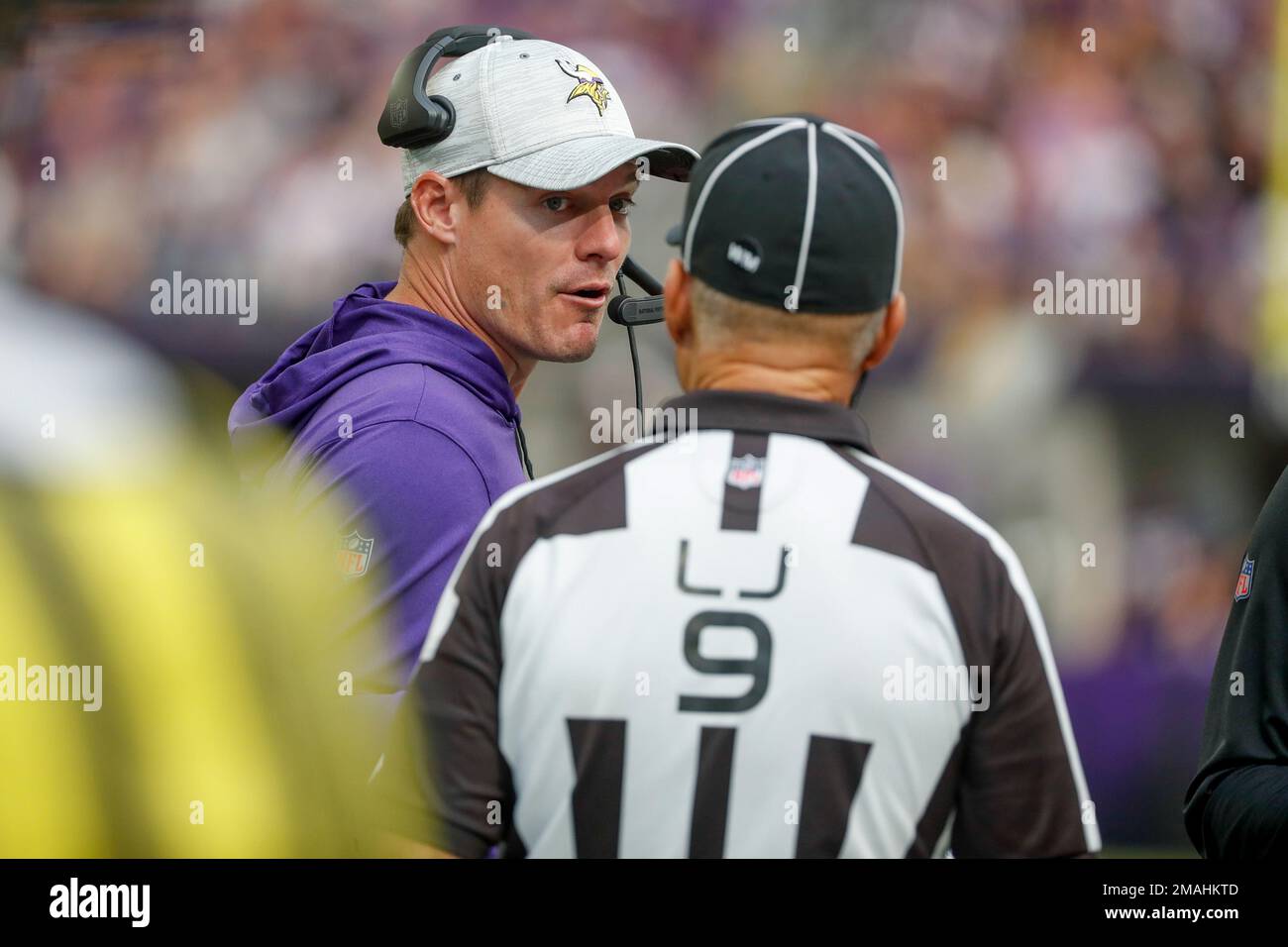 Minnesota Vikings head coach Kevin O'Connell, left, talks with line