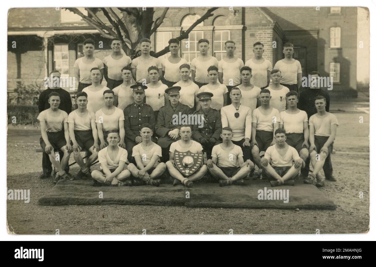 Original WW1 era postcard of group of young men of the Royal Norfolk Regiment in a sports team at a training camp U.K. circa 1916. Stock Photo
