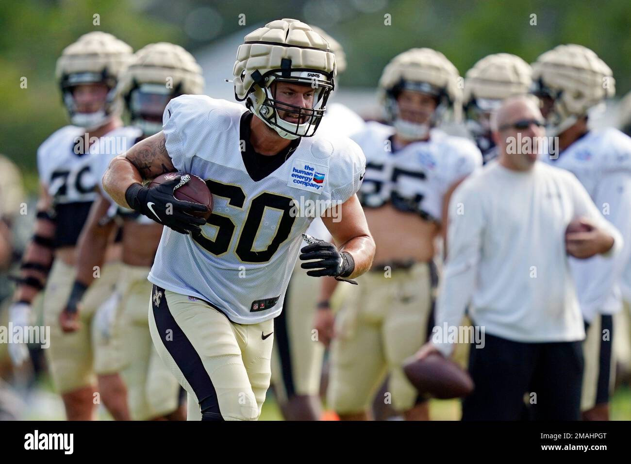 FILE - New Orleans Saints defensive end Scott Patchan (60) runs through  drills during training camp at their NFL football training facility in  Metairie, La., Thursday, Aug. 4, 2022. Guardian Caps helped