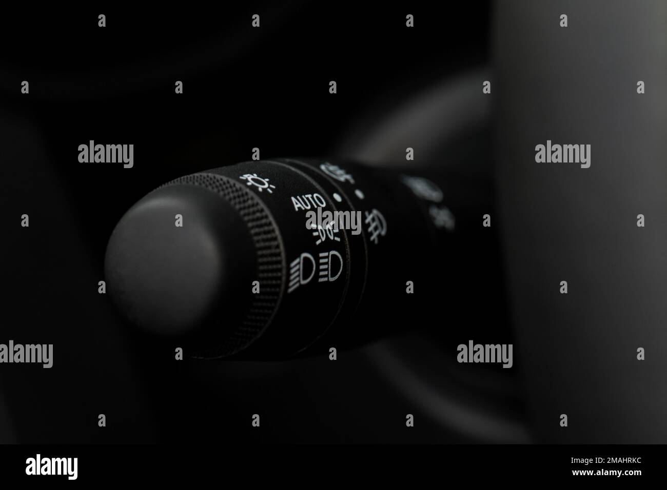 Modern car light switch. Turning on headlight in the car. Close up of