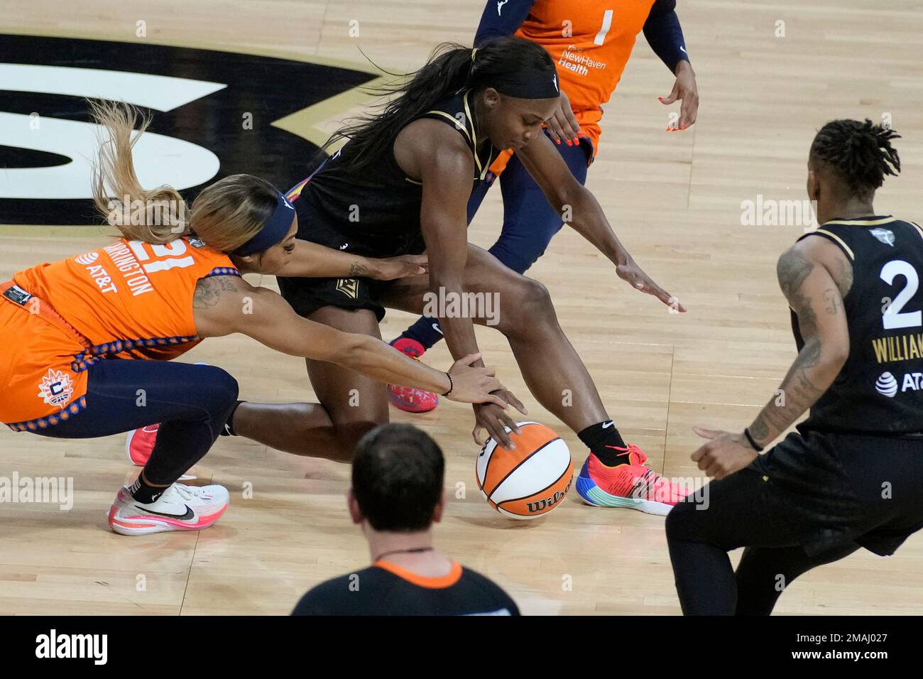 Connecticut Sun guard DiJonai Carrington (21) and Las Vegas Aces guard  Jackie Young (0) battle for the ball during the first half in Game 2 of a  WNBA basketball final playoff series