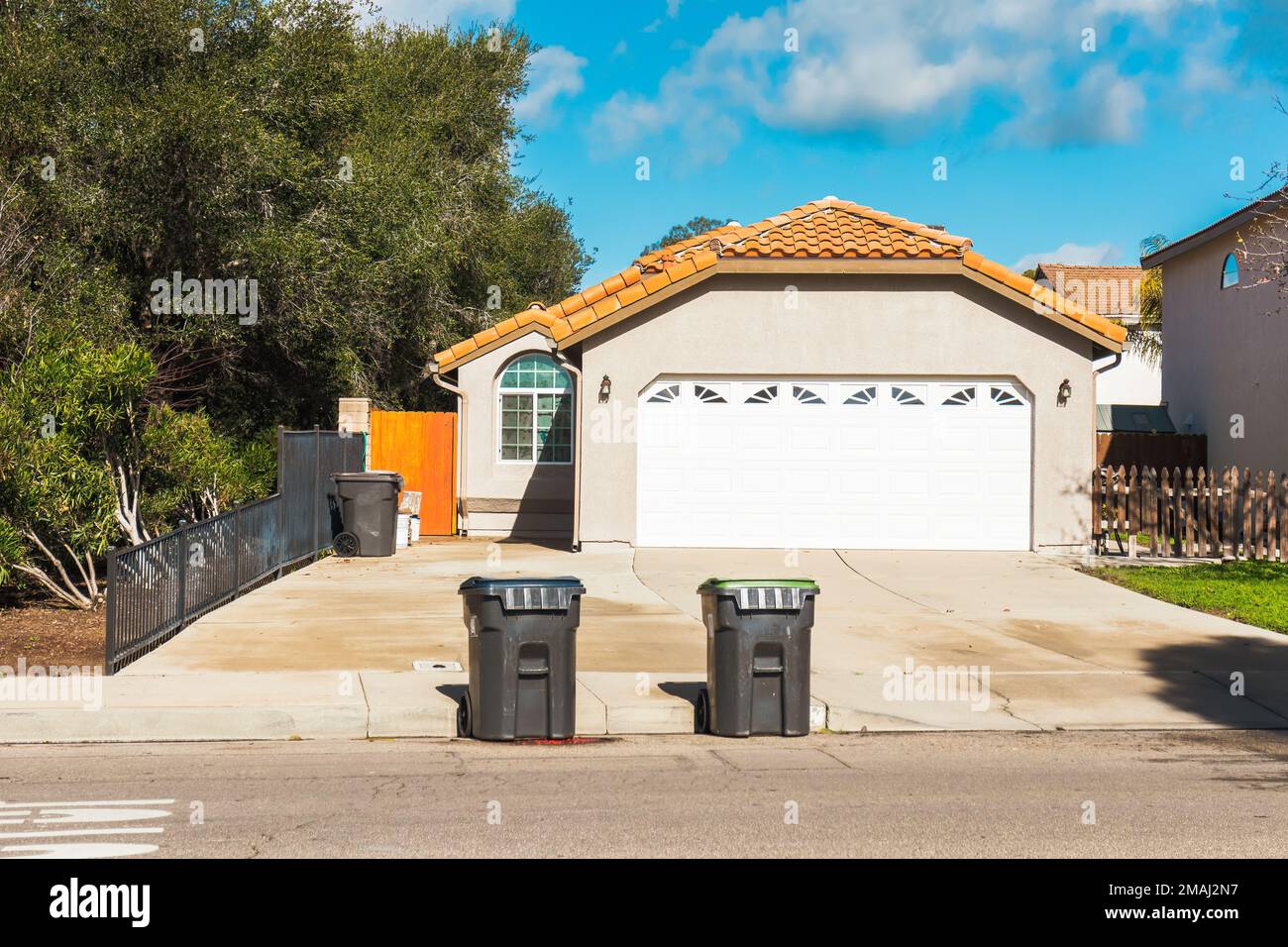 Beautiful houses with nicely landscaped front the yard, and wheeled ...