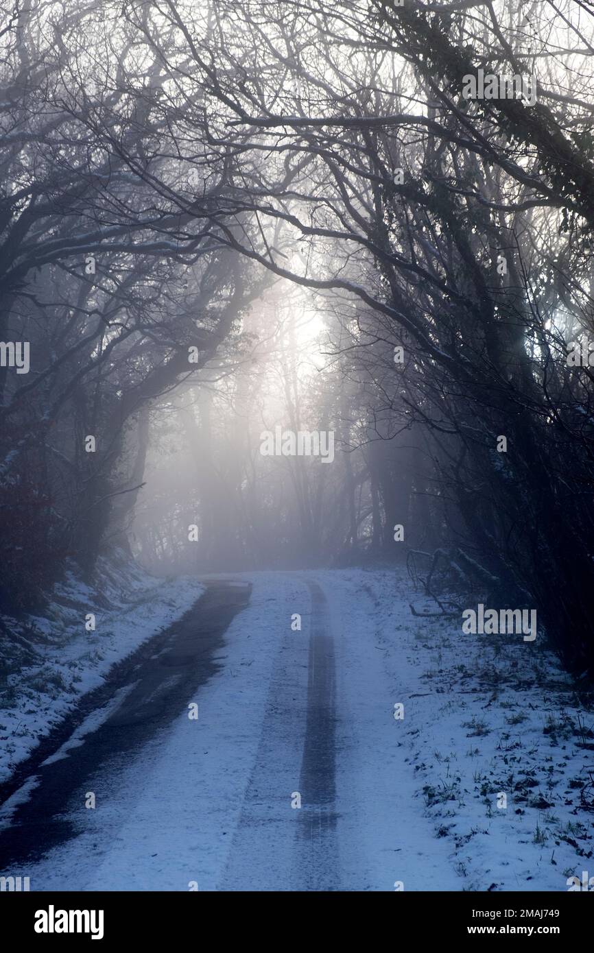 Ice freezing fog and frozen snow on rural road country lane in winter ...