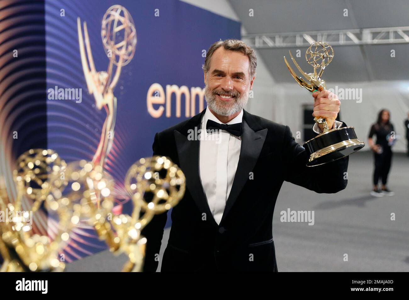 Murray Bartlett poses with the Emmy for outstanding supporting actor in