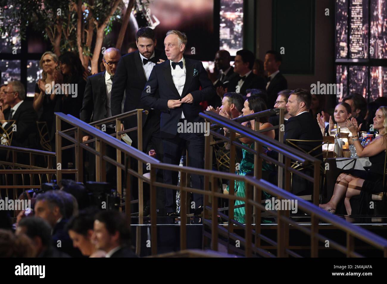 The team from "The White Lotus" stands after winning the Emmy for