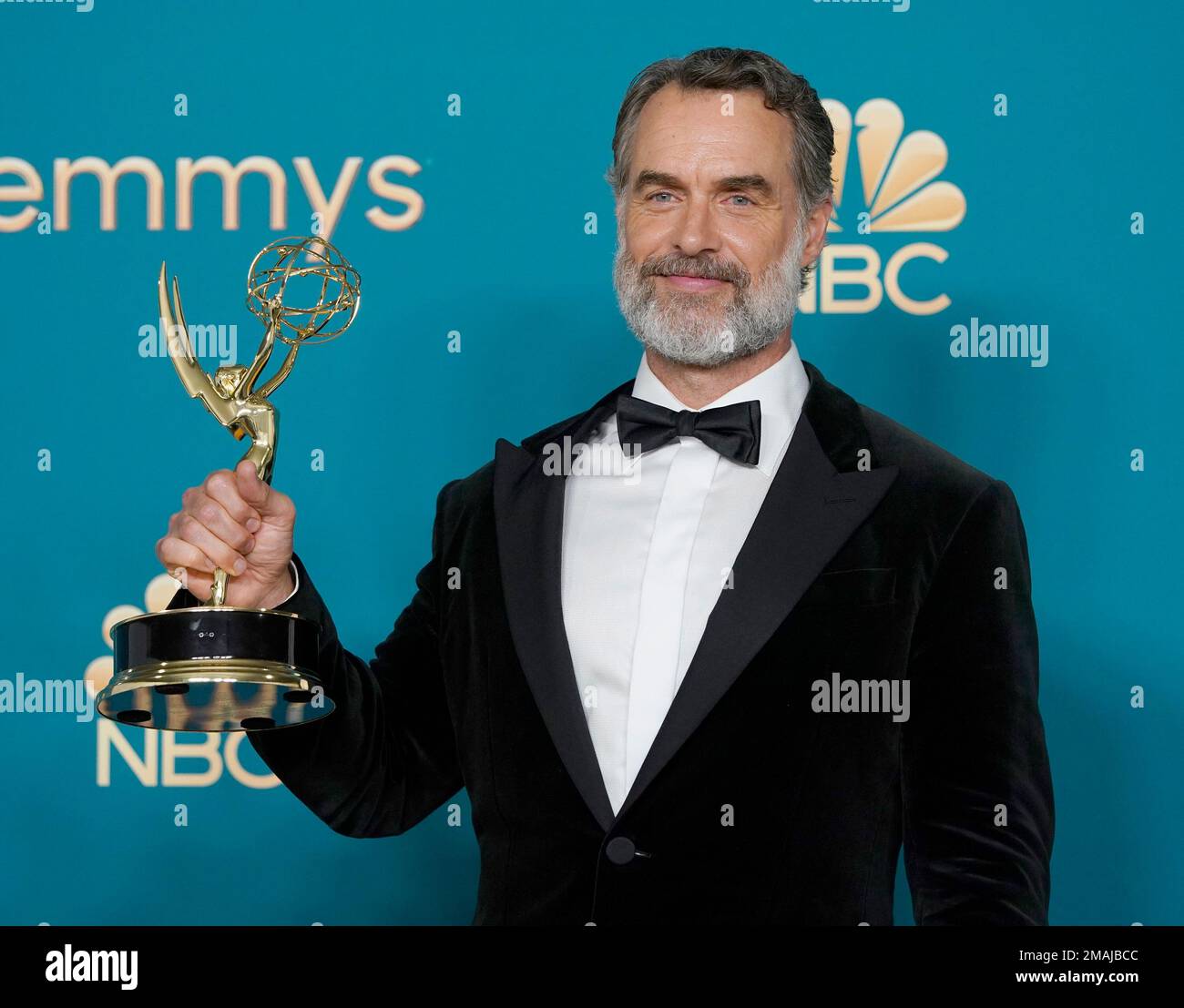 Murray Bartlett poses in the press room with the award for outstanding