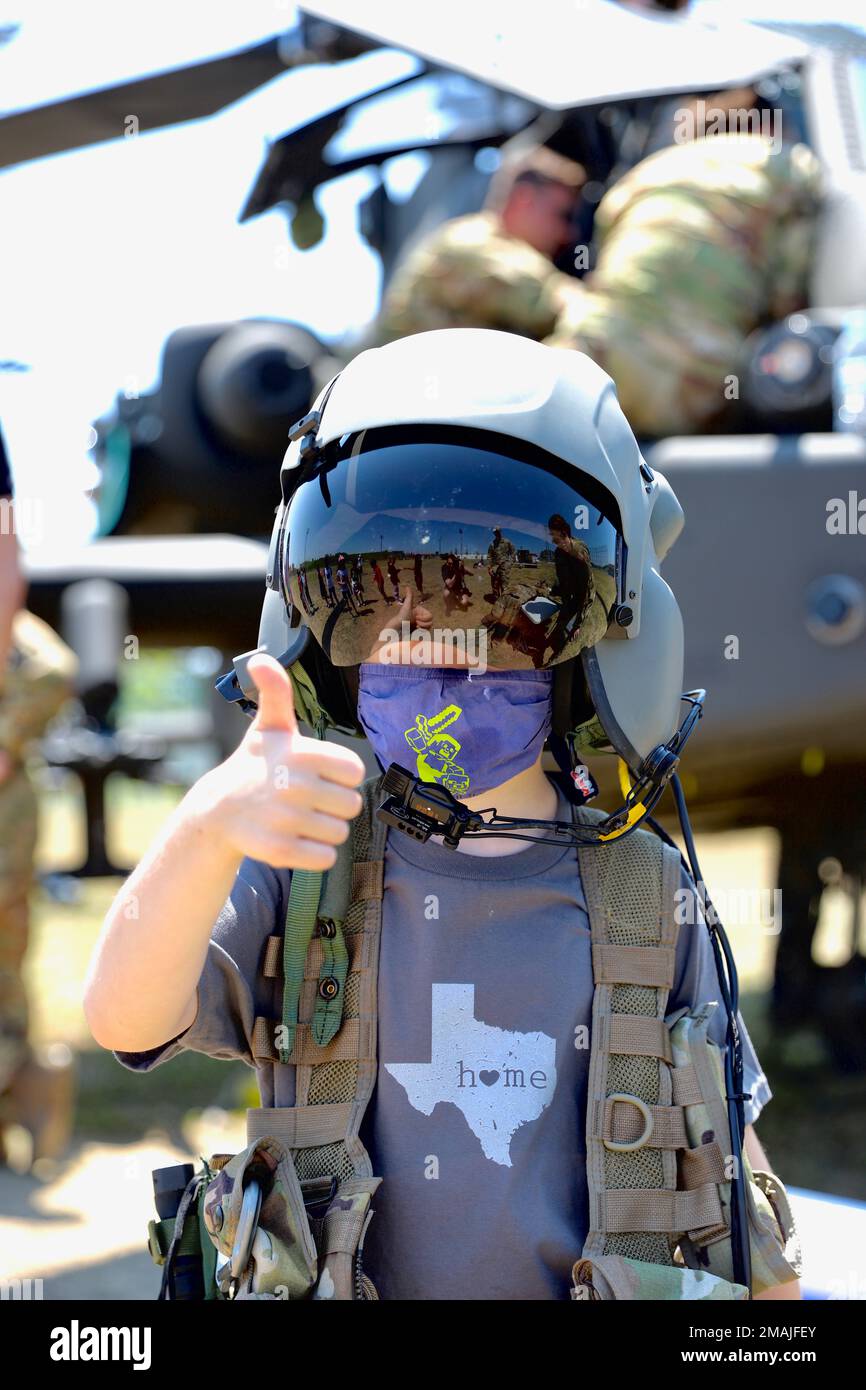 A USAG Humphreys elementary school student gives a thumbs up as he dons aviation life saving equipment and flight helmet during the 2nd Combat Aviation Brigade family day.    The 2nd Combat Aviation Brigade held a family day event on May 27-28, 2022 allowing family members throughout the brigade to get a hands on experience with the aircraft that their spouses work with daily. The children were able to sit in the cockpits of AH-64E, UH-60M and CH-47F aircraft as well as try on the flight gear that the aviators wear to fly those aircraft. Permission for release of the student was provided by US Stock Photo